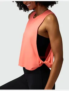 Side view of coral pink loose sleeveless sports tank top with side knot detail for women