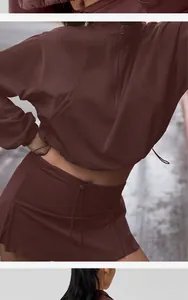Detailed view of maroon women's half-zip sweatshirt and drawstring sports skort set