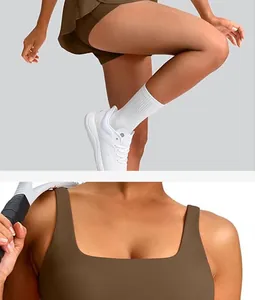 Close-up detail showing the brown sleeveless tennis dress and pleated skirt with shorts.