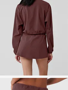 Back view of women's burgundy two-piece sports set with drawstring waist detail.
