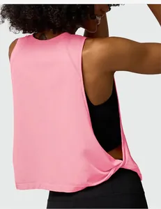 Close-up of pink loose workout tank top featuring a stylish twisted back hem detail