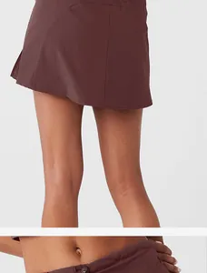 Detail view of a chocolate brown athletic skort showing the waistband and back hemline.