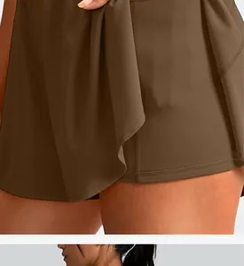 Detailed view of brown quick-dry tennis skort showing fabric texture and hemline finish