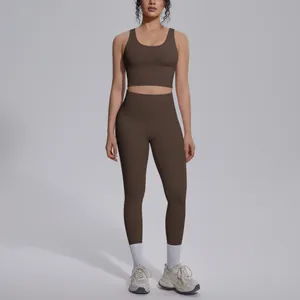 Two-piece brown yoga set for women featuring high-waisted leggings and sports bra