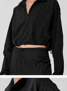 Detail showing the adjustable drawstring waist and half-zip collar of the black sport set
