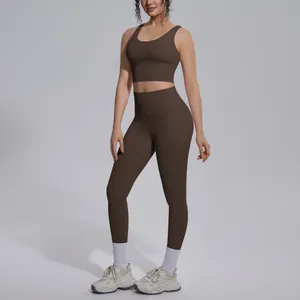Dark brown two-piece yoga set with V-neck sports bra and high-waist leggings on model