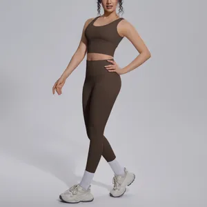 Full body view of a model wearing a mocha brown yoga set on a neutral background
