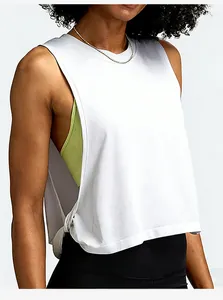 Detail view showing the loose fit of a white sleeveless yoga tank top for women