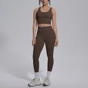 Full view of woman wearing brown naked-feel yoga set with v-neck bra and leggings