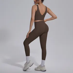 Rear view of women's brown yoga set with V-neck sports bra and high waist leggings