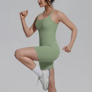 Detailopname van een vrouw in een saliegroene sporttop en nauwsluitende biker shorts
