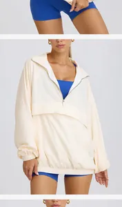 A detailed view showing the zip and collar texture of a cream women's loose fitness jacket