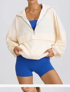 Women's cream half-zip sporty windbreaker with blue activewear set for gym training