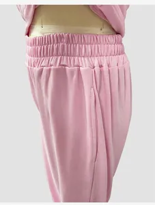 Close-up detail showing the elastic waistband and side pocket of pink casual sweatpants