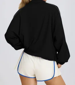Detailed back view of women's breathable half-zip sports jacket and athletic shorts