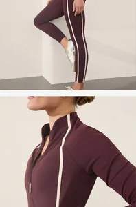 Close-up of burgundy yoga set with side stripes and slim-fit zip-up jacket design.
