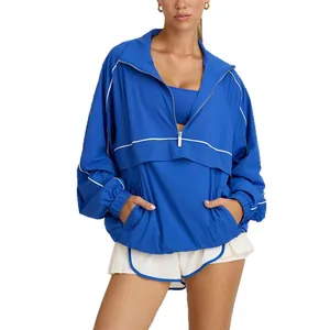 Women's breathable blue half-zip athletic jacket with white piping details and stand collar