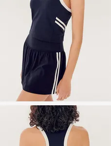 Close-up detail of navy blue and white color-block tennis skirt and sports tank top set.