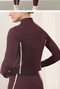 Detailed back view of a maroon women's yoga set featuring stylish cream side stripes