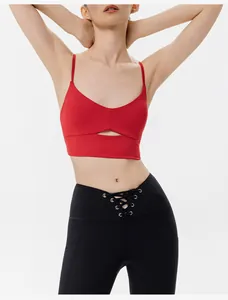 Dettaglio del reggiseno sportivo rosso e dei leggings neri con lacci sulla vita