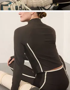 Back detail of women's dark brown yoga suit set with stylish white contrast piping