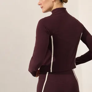 Women's burgundy yoga set with contrast piping, long sleeve top and leggings back view.