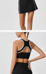 Detail view of black racerback sports bra with cutout and matching tennis skirt