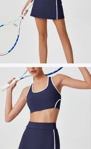 Detail view of navy blue high-waisted tennis skirt and sports bra set