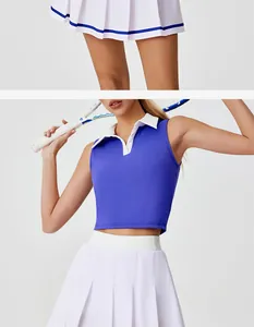Detalle de un top polo azul sin mangas y conjunto de falda de tenis plisada en blanco