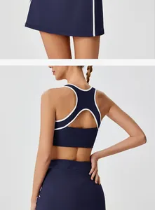 Back view detail of navy blue sports bra with white trim and racerback cutout design