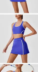 Professional view of blue tennis sports outfit with white trim on female model