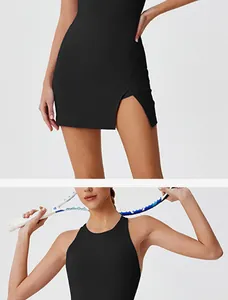 Detailed view of women's black backless tennis dress with side slit and racerback