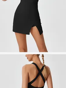 Close-up detail of backless cross-strap design and slit skirt on black athletic dress