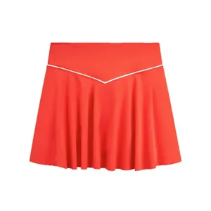 High-waisted vibrant orange pleated tennis skirt with decorative white V-shaped piping