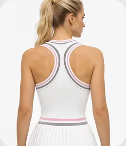 Detail of racerback tennis dress with pink and grey striped trim and pleated skirt