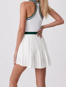 Close-up back view of a high-waist white pleated tennis skirt with green waist