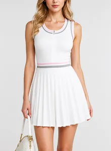 Close-up detail of the white athletic tennis dress featuring a pleated skirt and pink stripes