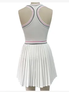 Back view of a white pleated tennis dress with pink and grey striped trim and racerback