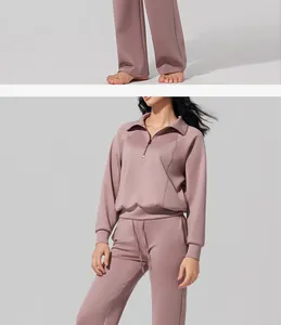 Close-up of women's half-zip mauve tracksuit with high-waist joggers in air layer fabric