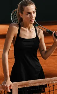 Model wearing breathable black mesh athletic tennis dress on a professional court