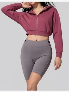 Maroon women's zip-up cropped hoodie and grey biker shorts for fitness and yoga