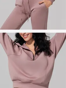 Close-up of mauve half-zip sweatshirt and high-waisted drawstring joggers set
