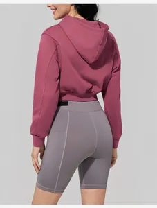 Detailed back view of a pink cropped hoodie paired with grey seamless gym shorts