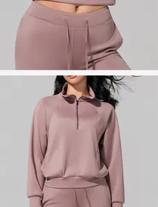 Detailed view of mauve half-zip sweatshirt and high-waist yoga pants with drawstring