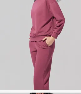 Detalle de un elegante conjunto de sudadera granate de cuello redondo y pantalón jogger.