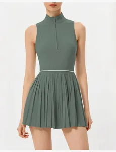 Detalle de cuello alto y cremallera frontal en vestido deportivo plisado verde salvia.