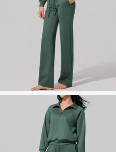 Detail view of women's green air layer half-zip sweatshirt and wide-leg sports pants set.