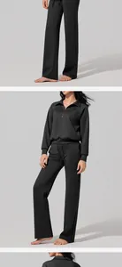 Detailed view of the women's black scuba fabric half-zip sweatshirt and matching pants.