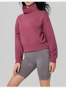 Side view showing the comfortable fit of a burgundy funnel neck long-sleeved sweatshirt