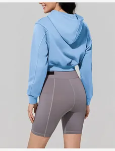 Back view of women's light blue cropped zip-up hoodie for fitness and gym workouts
